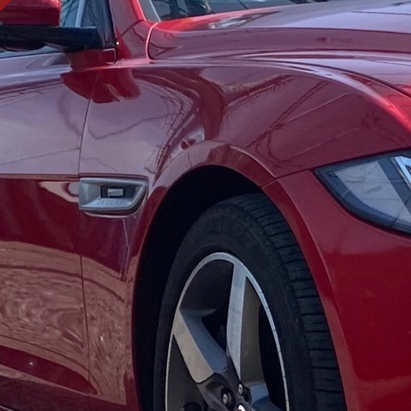 a close up of a red sports car