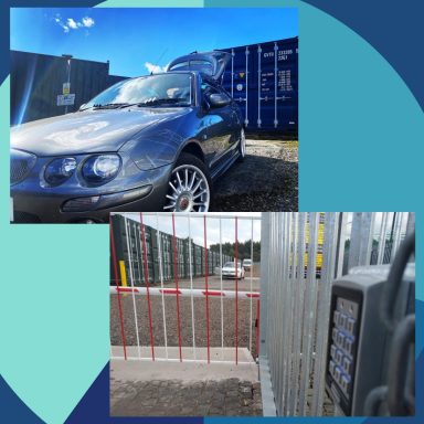 Blue car parked near storage containers with a fenced entrance and keypad.