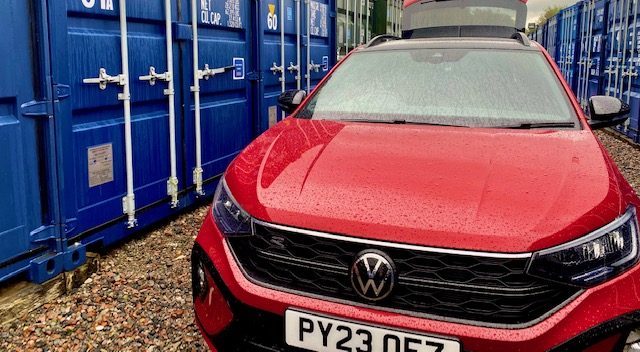 car parked beside a storage locker