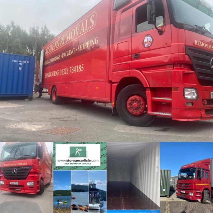 A red removals lorry parked next to a shipping container on a self storage facility unloading.